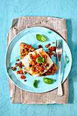 Fried cod with an aubergine and tomato salsa