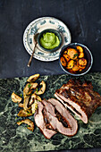 Stuffed veal breast with roasted artichokes and almond basil pesto