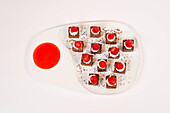 Chocolate cake cubes with cream and raspberries
