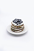 Blueberry pancakes with cream and fresh blueberries