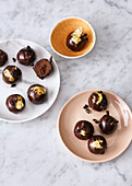 Mezcal balls with fine chocolate coating and dried apricots