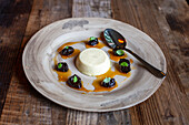 Panna cotta with dried plums and basil