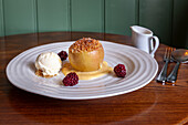Baked apple with crumble, blackberries and ice cream