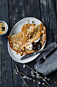 Vegan pancakes with hazelnut puree and damson puree