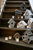 Birdhouses and lanterns as staircase decoration