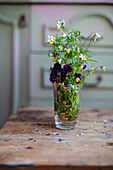 Posy of heartsease in glass of water