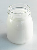 A jar of yogurt on a white background