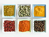 Six different spices in small bowls