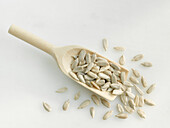 Sunflower seeds on a wooden scoop