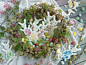 Easter wreath made of willow and ornamental currant with Easter bunnies made of meringue