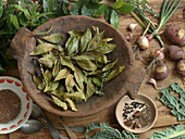 Fresh and dried bay leaves in a wooden bowl