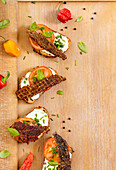 Jerky open sandwiches on a wooden background