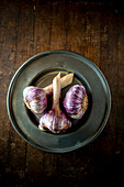 Fresh Garlic pods on a metal Plate