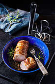 Bacon wrapped Pork fillet in a pan