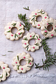Christmas wreath cookies filled with jam, coated with white rice milk chocolate, vegan