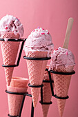 Vegan strawberry coconut ice cream in waffle cones