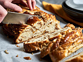 Slicing a loaf of braided nut bread