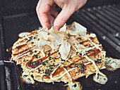 Top Okonomiyaki (Japanese pizza) with Katsuobushi (bonito flakes)