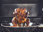 Tandoori chicken on a vertical poultry roasting tray