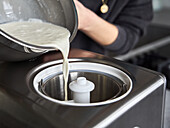 Egg free vanilla ice cream being poured into the ice cream maker