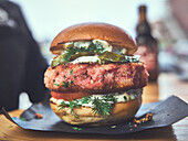 Salmon burger with mayonnaise, pickle and dill