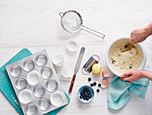 Baking scene with muffin tin and muffin batter