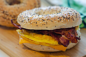 Bagel breakfast sandwich made with cheese, scrambled eggs and bacon