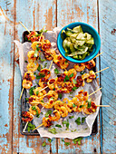 Skewers with masala prawns and pickled cucumber