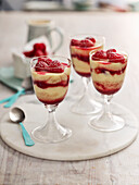 Layered dessert with vanilla pudding and raspberries