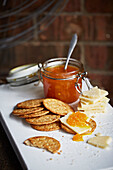 Cheese and biscuits with a jar of chutney