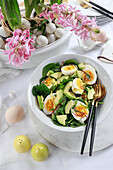 Egg, avocado and spinach salad on Easter table
