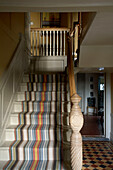 Striped carpet contrasts with chequered floor in Rye entrance hallway Sussex