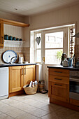 Wood fitted units in kitchen of Norfolk beach house, UK