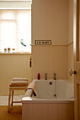 Einfaches cremefarbenes Badezimmer in einem Strandhaus in Norfolk, UK