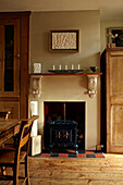 Wood burning stove in recessed fireplace of Brighton dining room, UK