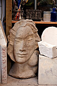 Carved female head in workshop of Brighton home, Sussex, UK