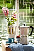 Coffee pot and cut flowers in houseboat in Richmond upon Thames, England, UK