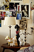 Animal figurines and silver candlestick on wooden side table in Lincolnshire home, England, UK