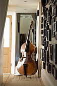 View past family photographs on wall to cello