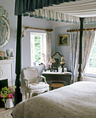 Oak four poster bed in traditional country style bedroom