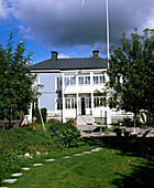 Exterior of blue painted timber house with veranda