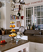 Tiered fruit bowl on kitchen unit with jug of water