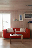 Wooden coffee table in front of red sofa in country style room