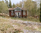 Exterior of a traditional wooden house on a wooded hillside