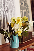 Daffodils on wooden shelf in work studio of artist and printmaker