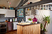 Wood panelled breakfast bar in vintage kitchen of Brighton home East Sussex, UK