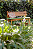 Bench seat with shopping bag in summer garden