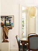 Dining room table with light blue upholstered chairs pendant lights sculpture from Brazil