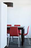 Pink chairs at dining table in white room