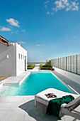 Swimming-pool with a direct view of the sea and a tiled path leading to the beach